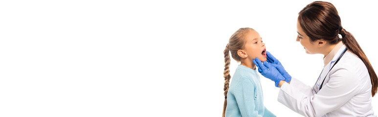 Panoramic shot of smiling pediatrician looking at girl with open mouth isolated on white