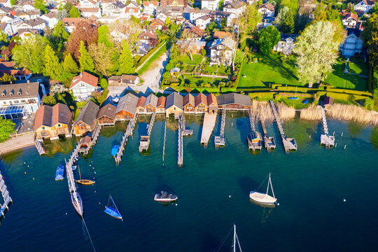Germany, Bavaria, Tutzing, Sailboats in front of boathouses on shore of Lake Starnberg