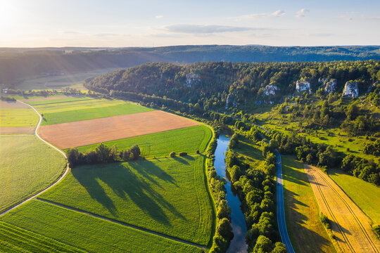 Germany, Bavaria, Kipfenberg, Drone view of river Altmuhl and Arnsberger Leite formation at springtime sunset