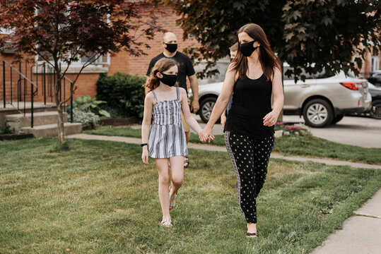Family with protective masks during stroll outdoors