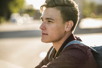 Thoughtful handsome young man looking away