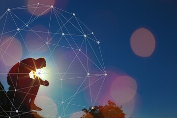 Young man pray outdoor on top of mountains in sunset