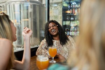 Happy female friends socializing in a pub
