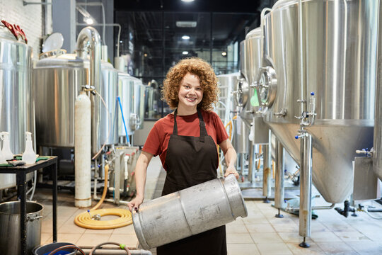 Portrait of smiling woman working in craft brewery