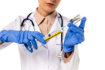 Cropped view of doctor picking up vaccine in syringe with covid-19 lettering isolated on white