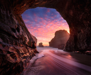 Scenic view of sea and cave during sunset