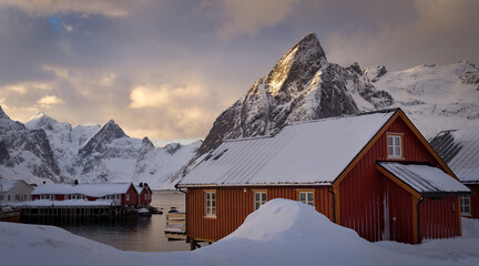 View of fishing cabins with snowcapped mountains in background