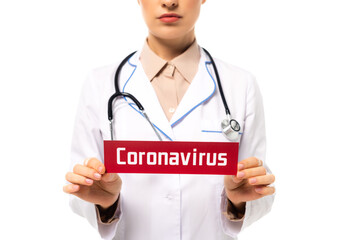 Cropped view of doctor holding card with coronavirus lettering isolated on white