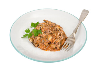 Plate with pieces of chopped canned fish in tomato sauce