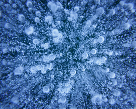Close up of ice bubbles and patterns in frozen lake