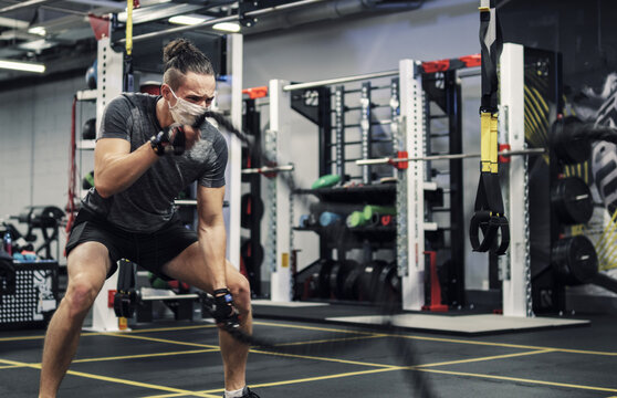 Pandemic Gym - Man Working Out With Protective Face Mask During Coronavirus Outbreak