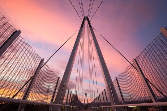 Low angle view of Mary Avenue Bridge against cloudy sky during sunrise