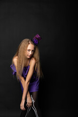 Teenage girl on black background of Halloween