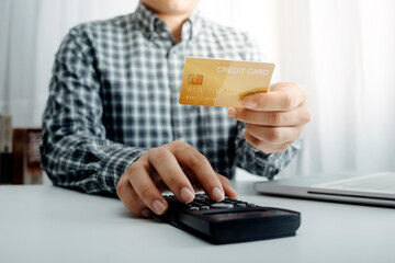 businesswoman hand using smart phone, tablet payments and holding credit card online shopping, omni channel, digital tablet docking keyboard computer at office in sun light