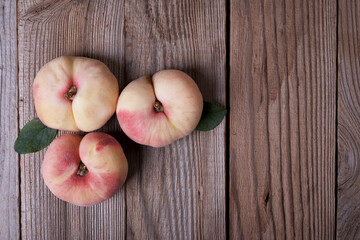 Fresh sweet fig peaches on wooden background