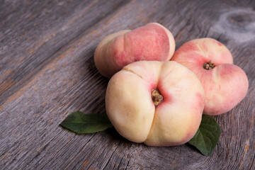 Fresh sweet fig peaches on wooden background