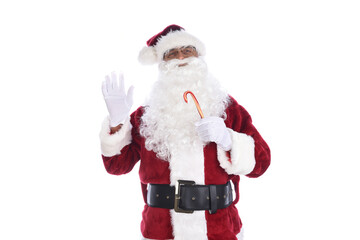 Senior man in traditional Santa Claus costume holding a candy cane in one hand and waving with the other. Isolated on white.