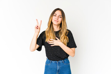 Young caucasian woman isolated on white background taking an oath, putting hand on chest.