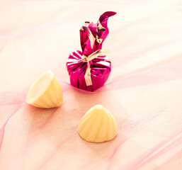 Assorted, exotic white milk chocolate toffees on a soft background.