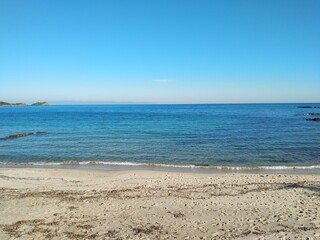 Fototapeta na wymiar Beautiful mediterranean calm sea at Nora beach near Pula in Sardinia,Italy