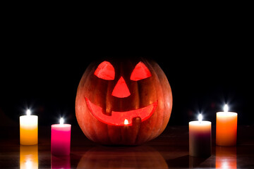 jack o lantern pumpkin with candle on the table, halloween night scene