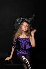 Teenage girl on black background of Halloween