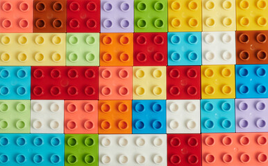 Flat background of plastic colorful bricks