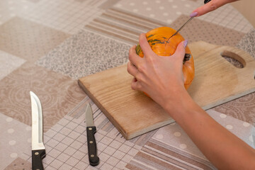 the process of making a Halloween pumpkin. horror theme and Hallowe'en.