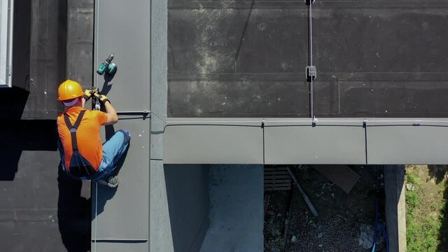 Lightning Protection System Installation to Protect Building From Elements. Caucasian Technician Finishing Installation