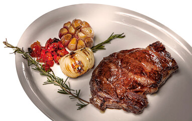 grilled pork chop with garlic and onion and red pepper with rosemary garnish on a white plate