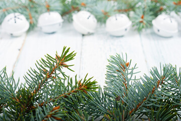 pine tree branches frame with snowflake shape decorations on old wood table, Christmas background