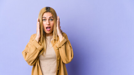 Young blonde caucasian woman surprised and shocked.