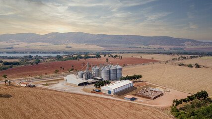 Aerial view of agricultural silos near the highway. Aerial drone image.