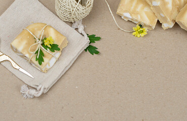 handmade soap made from squeezing soap slivers on wrapping paper, the concept of spa and self-care at home, packing a gift made with your own hands, copy space