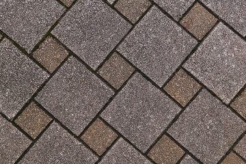 fragment of sidewalk from square tiles of different sizes