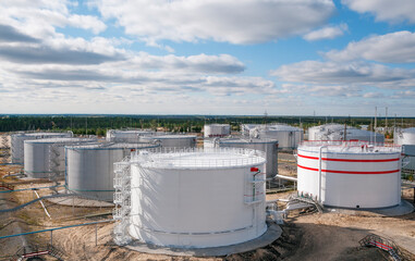 Cloudy day. Tanks with oil for further transportation of oil through pipes at an oil refinery and oil pumping station