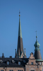 Roofs in the old town Gamla stan in Stockholm, the German church and old houses a sunny day