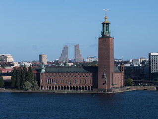 Obraz premium Part of Stockholm skyline with the Town City Hall, Waterfront and twin towers a sunny hazy morning