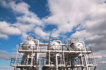 Obraz premium Industrial equipment at an oil refinery station. Oil and gas industry, oil refining and refining