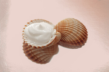 mousse, foam, soap in a sea shell on a shiny background, skin care and maintenance with natural sea salts and minerals