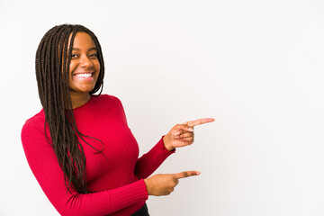 Young african american woman isolated excited pointing with forefingers away.