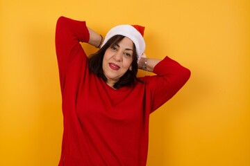 Confidence and coquettish concept. Portrait of charming young business girl, smiling broadly with self-assured expression while holding hands over her head. Standing against background.