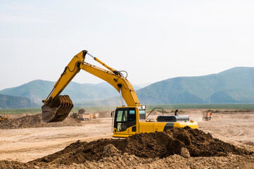 Excavator bucket awaiting loading into the tipper body