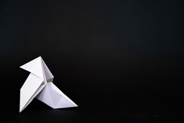origami bird on a black background