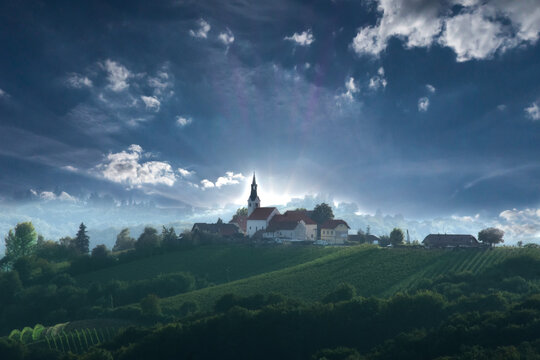Abstract HDR image of picturesque church with wineyards in Prlekija, eastern wine region of Slovenia. Sunset above hill near Jeruzalem, Svetinje, Ljutomer