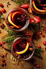 Mulled red wine with spices and citrus fruit in glasses top view. Traditional Christmas drink