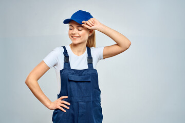 woman in work uniform blue cap service delivery service light background