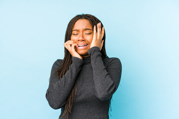 Young african american woman isolated on blue background whining and crying disconsolately.