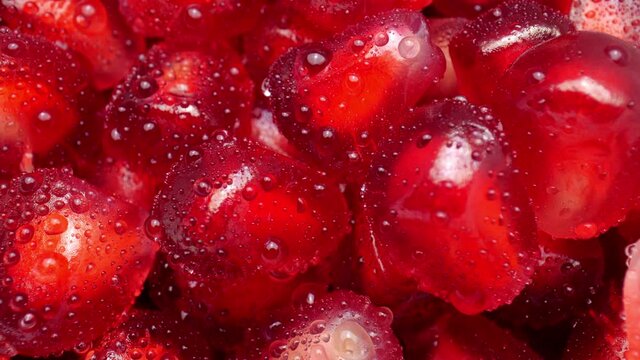 Fresh red pomegranate seeds. Red ripe juicy pomegranate seeds close up.