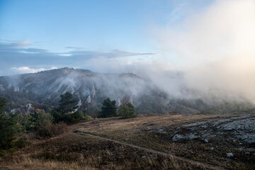 sunrise in the mountains with morning fog from early autumn